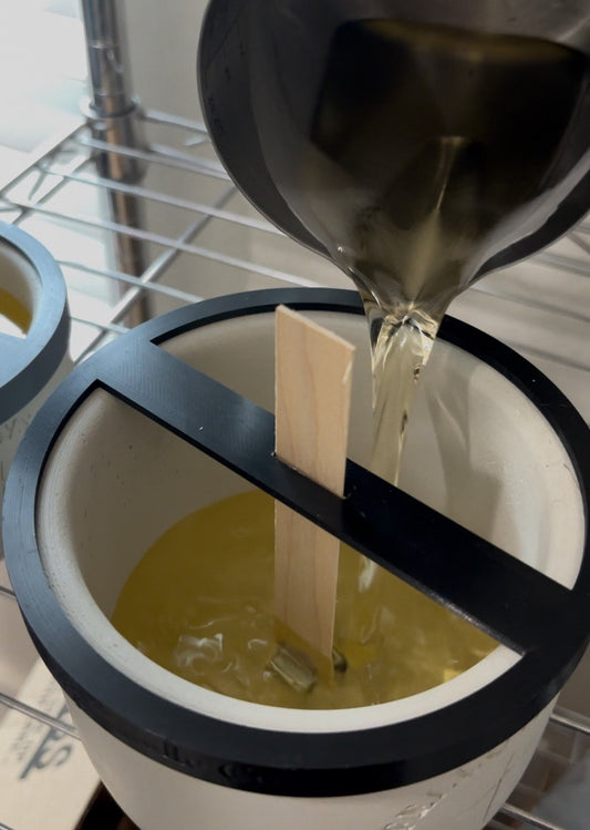 Soy wax being poured into fellowship candle vessel