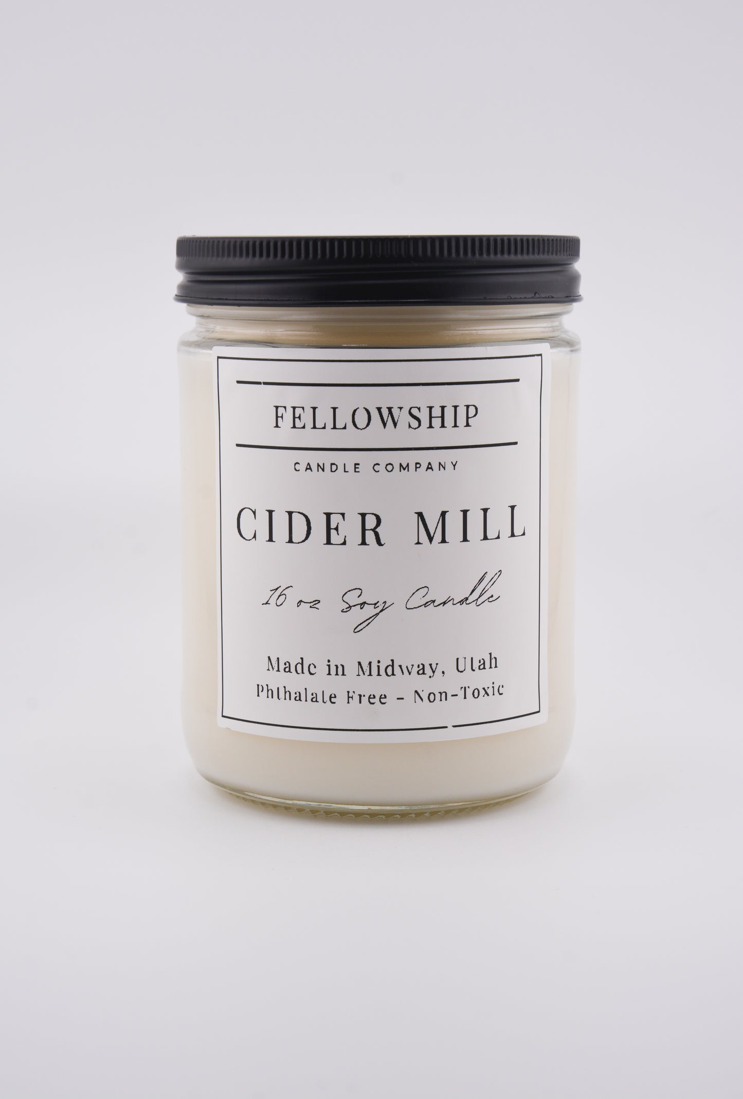 Candle jar labeled 'Fellowship Candle Company Cider Mill' on a white background