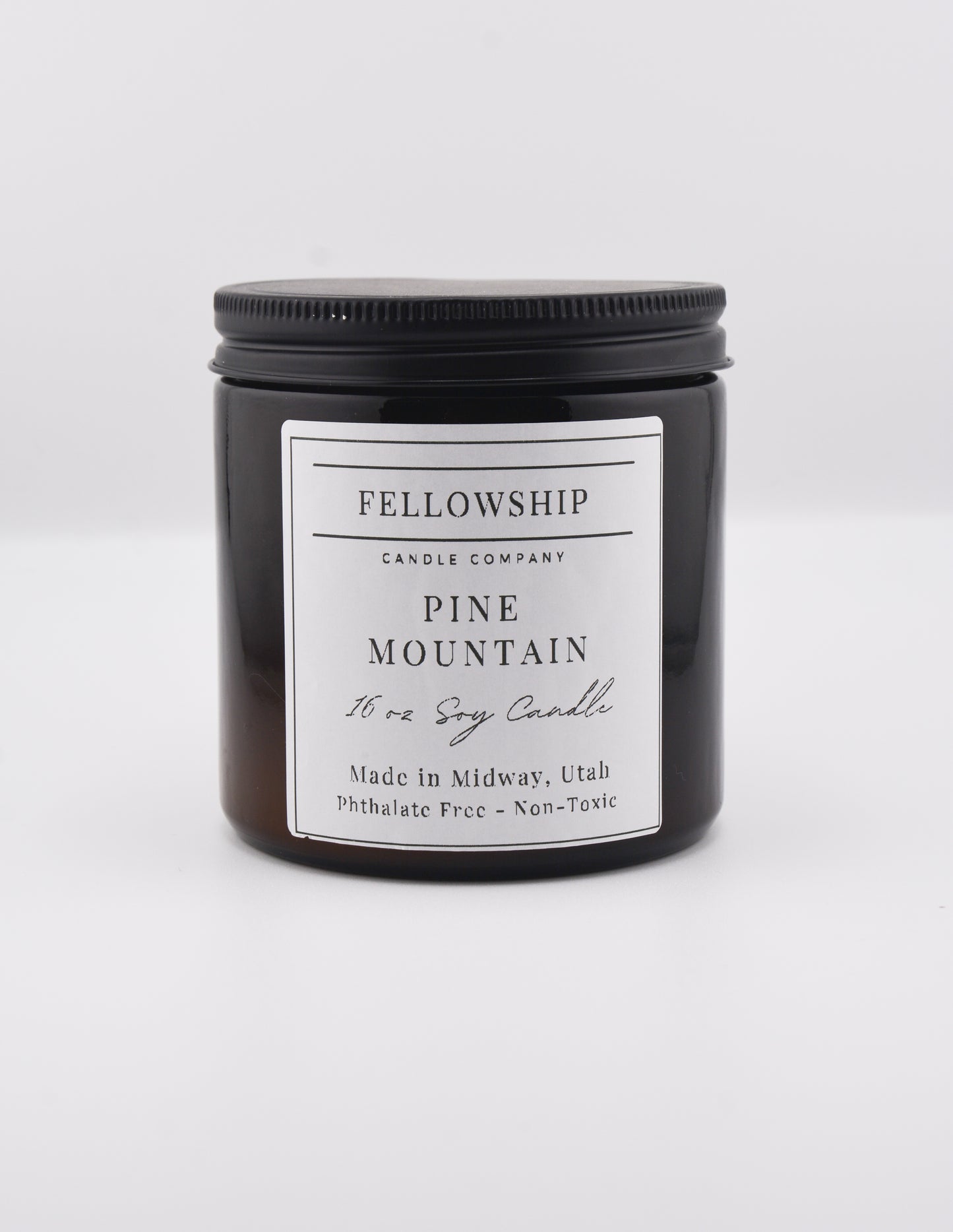 Fellowship Candle Co. candle with a white label on a white background