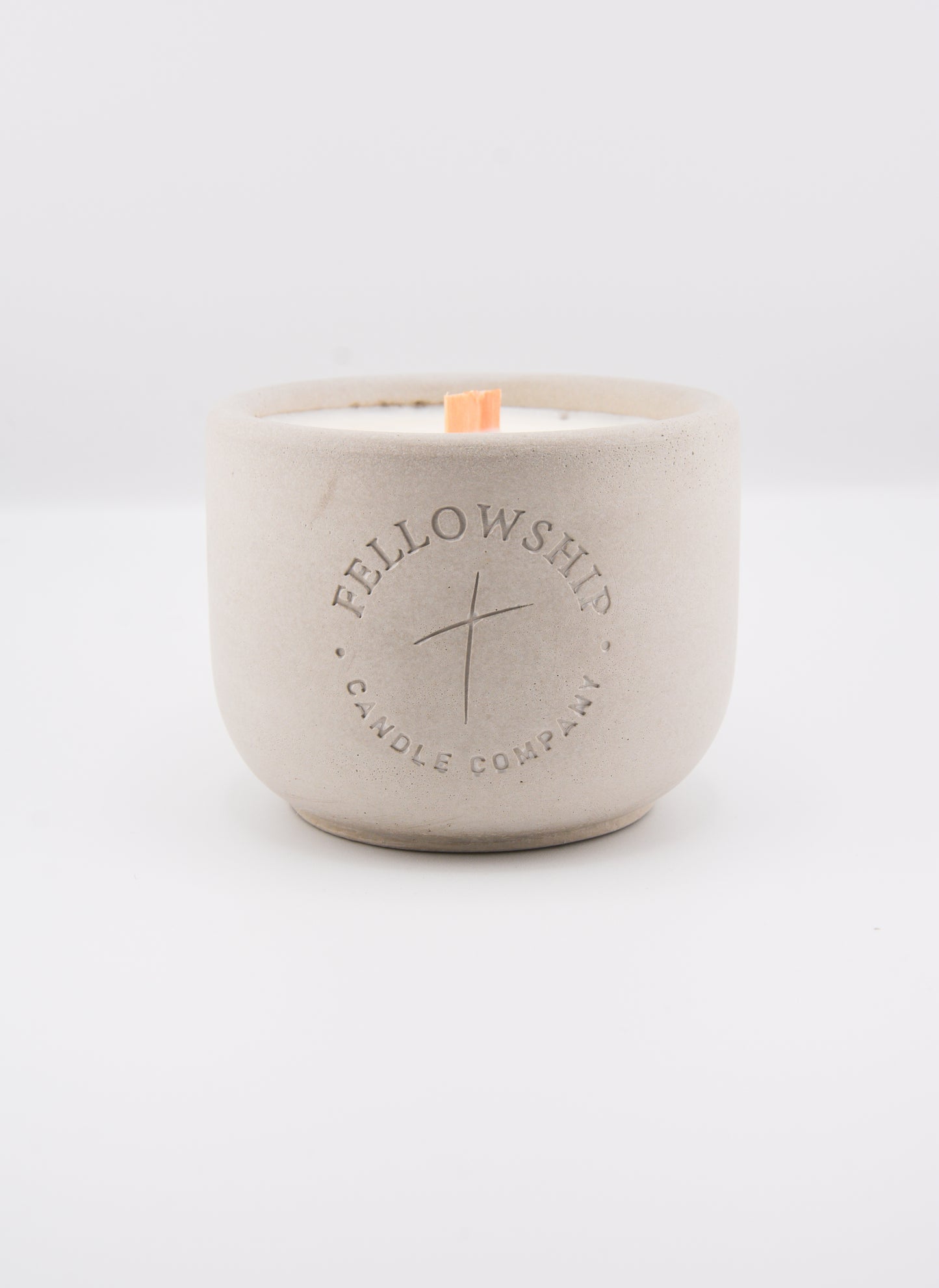 Concrete candle jar with 'Fellowship Candle Company' branding on a white background
