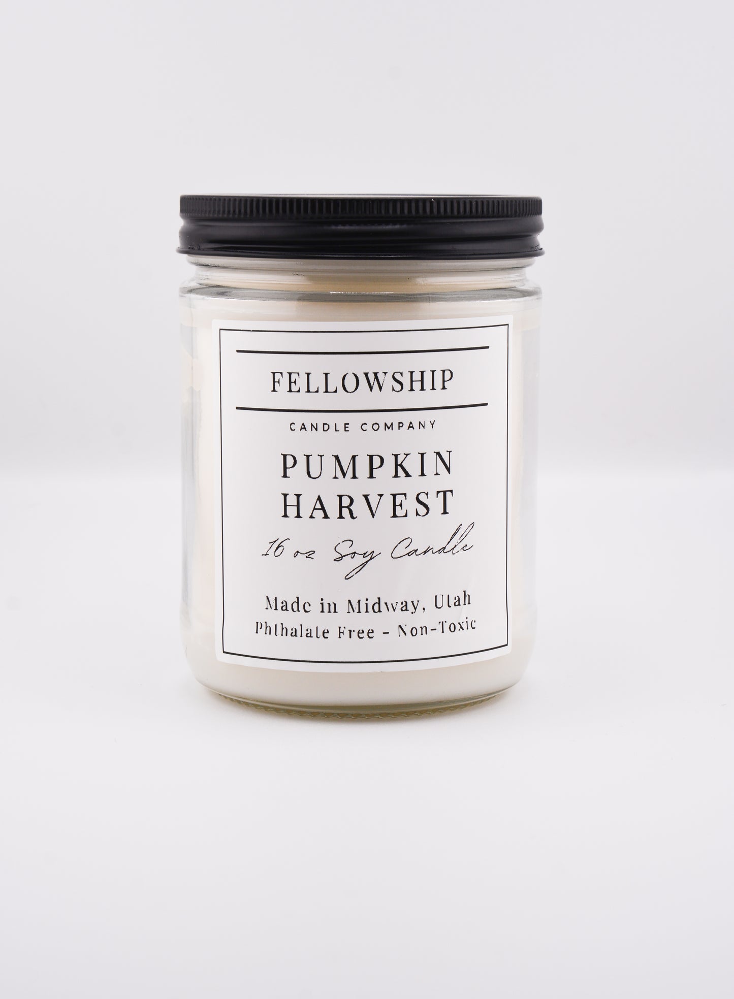 Candle with 'Fellowship Candle Company' label on a white background