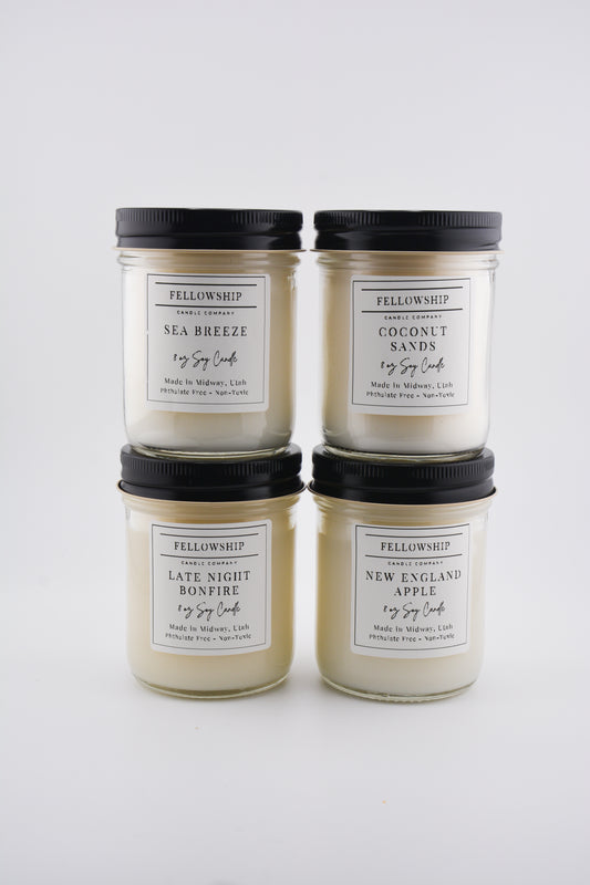 Four Fellowship candles with labels on a white background
