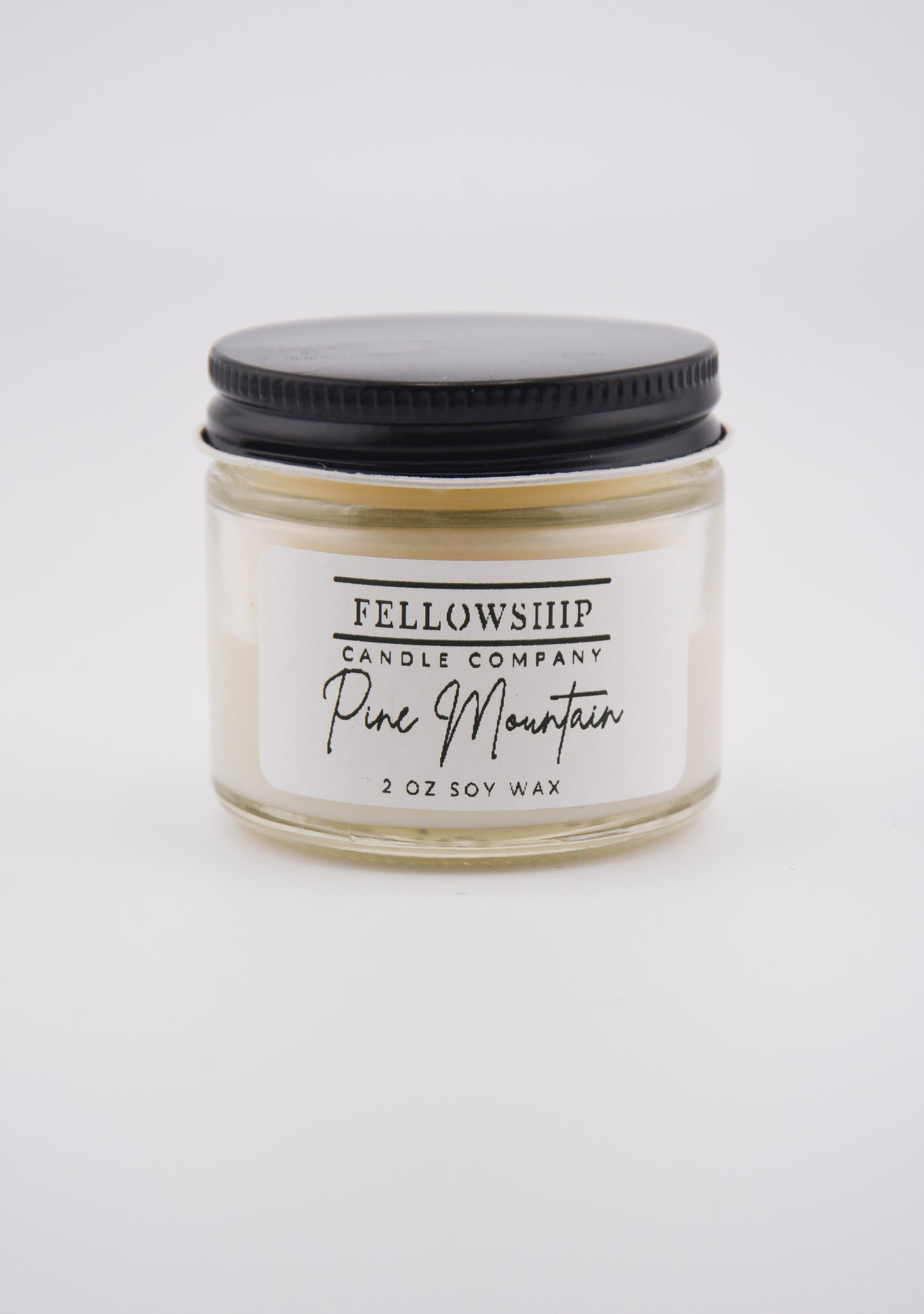 Fellowship Candle Company non-toxic candle with a black lid on a white background