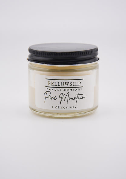 Fellowship Candle Company non-toxic candle with a black lid on a white background