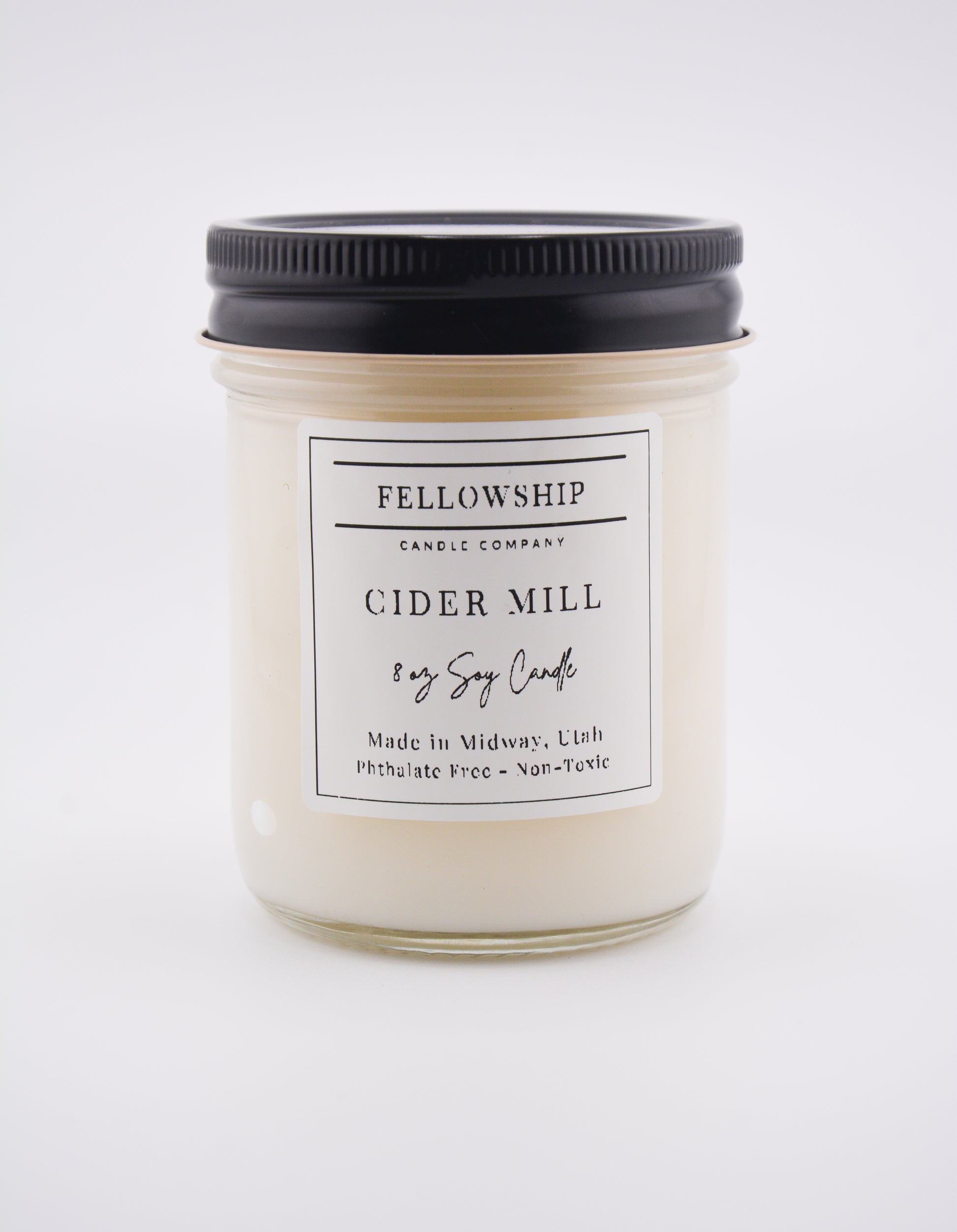 Candle jar labeled 'Fellowship Candle Company Cider Mill' on a white background