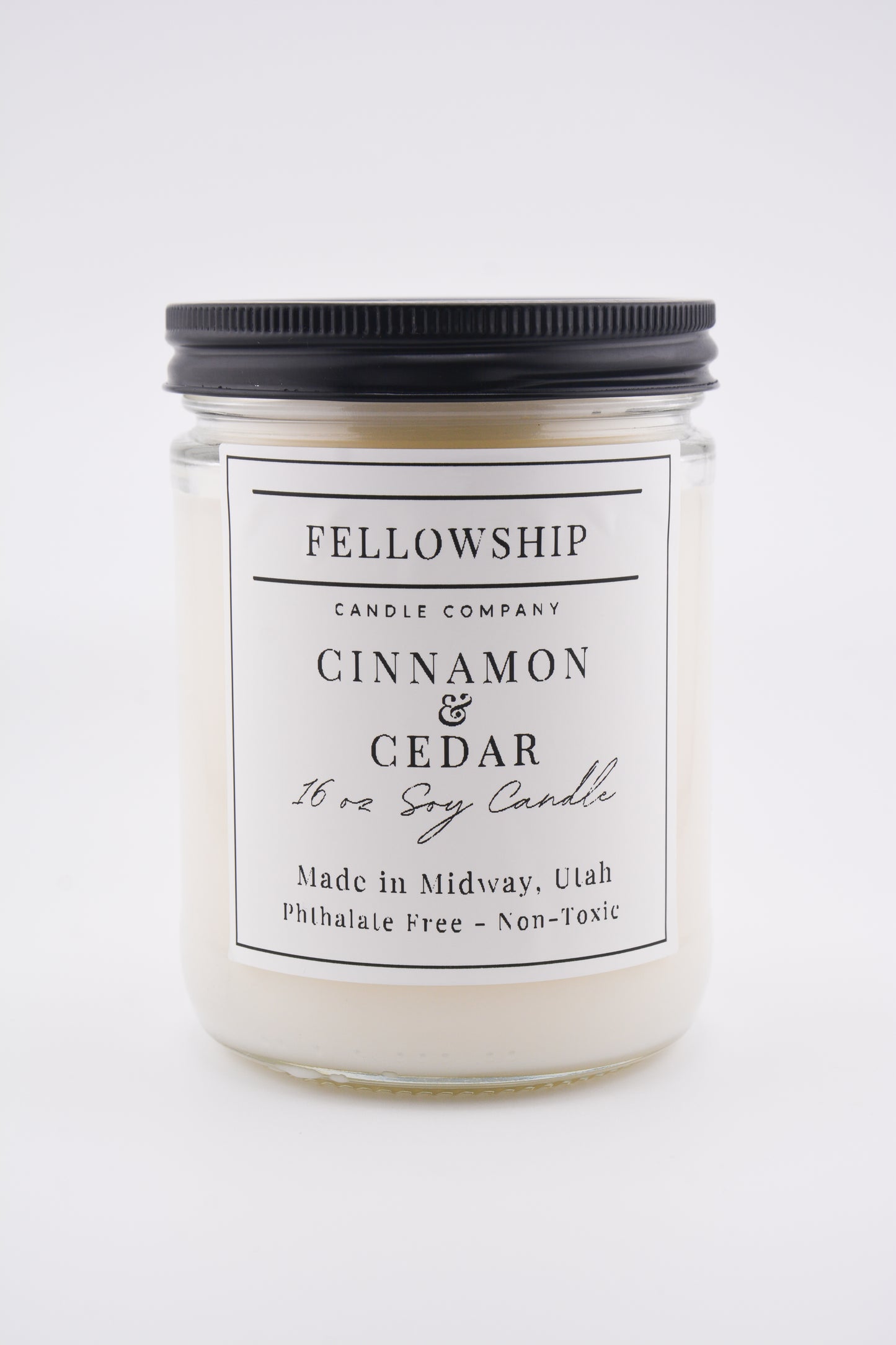 Candle jar with 'Fellowship Candle Company' label on a white background