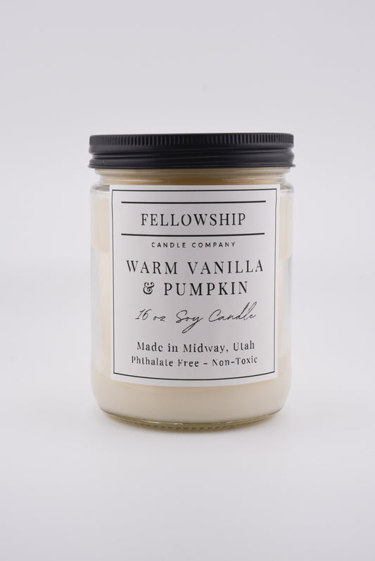 Candle jar labeled 'Fellowship Candle Company' with 'Warm Vanilla & Pumpkin' scent on a white background