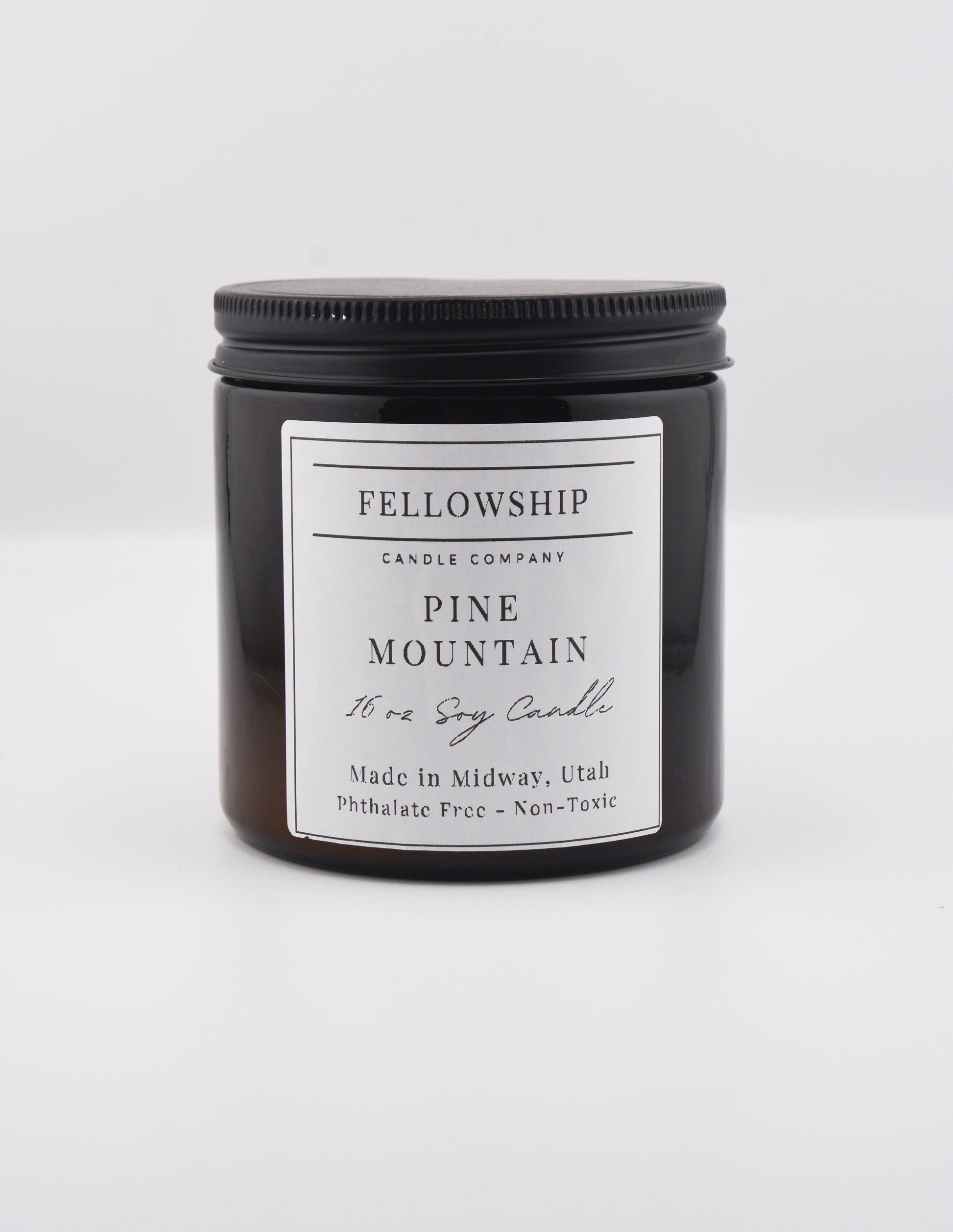 Fellowship Candle Co. candle with a white label on a white background
