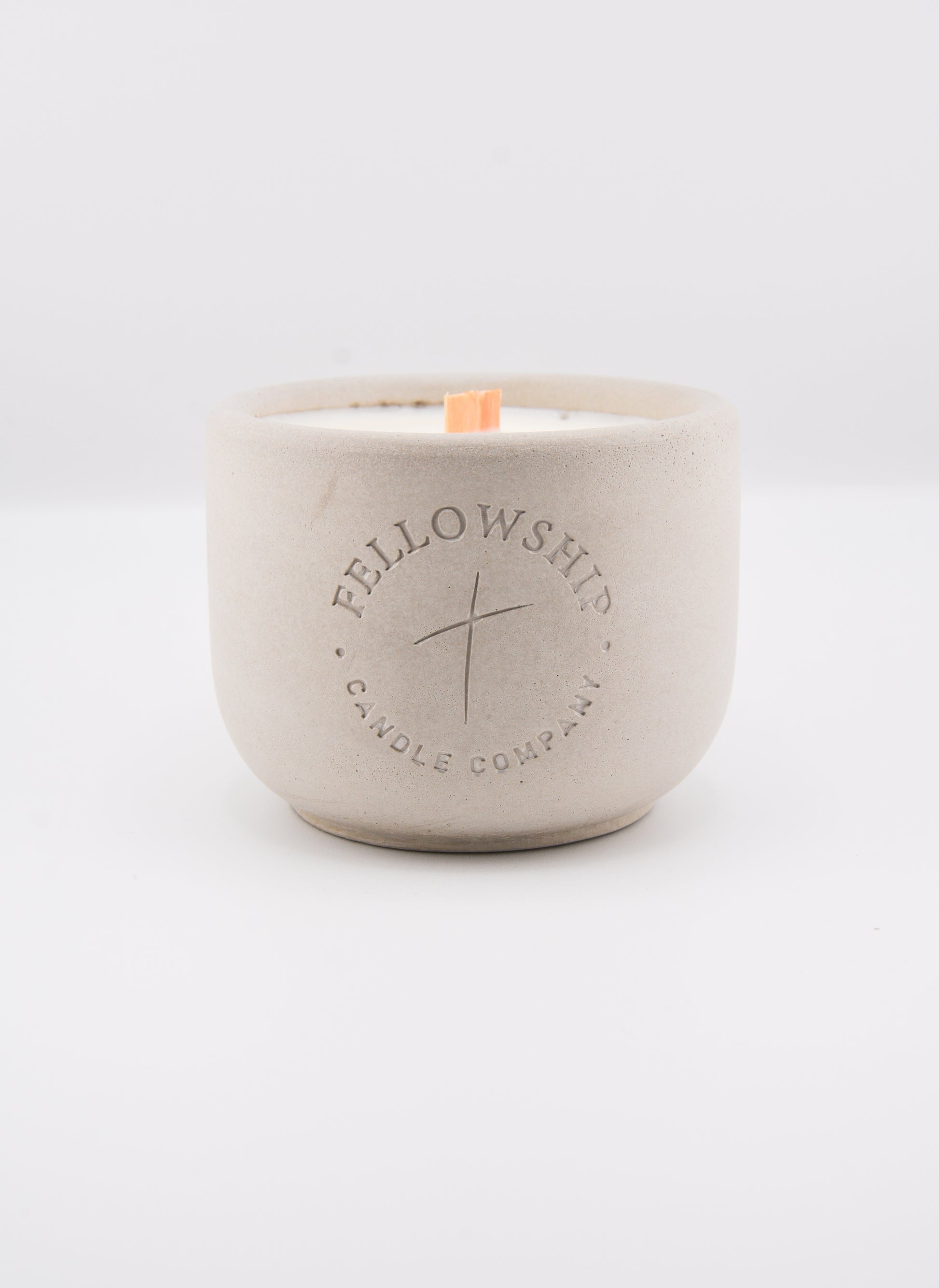 Concrete candle jar with 'Fellowship Candle Company' branding on a white background