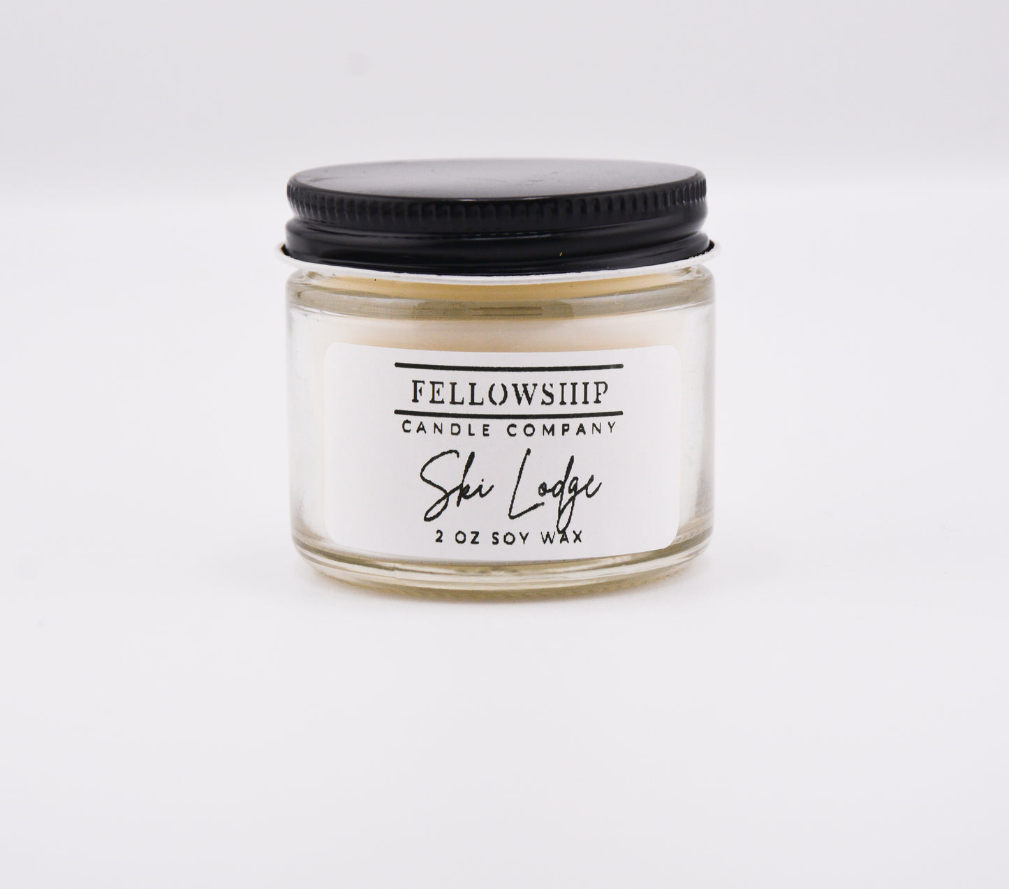 Candle jar with black lid and 'Fellowship Candle Company' label on a white background