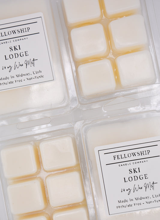 Packaged wax melts with 'Fellowship Candle Company' labels on a white background