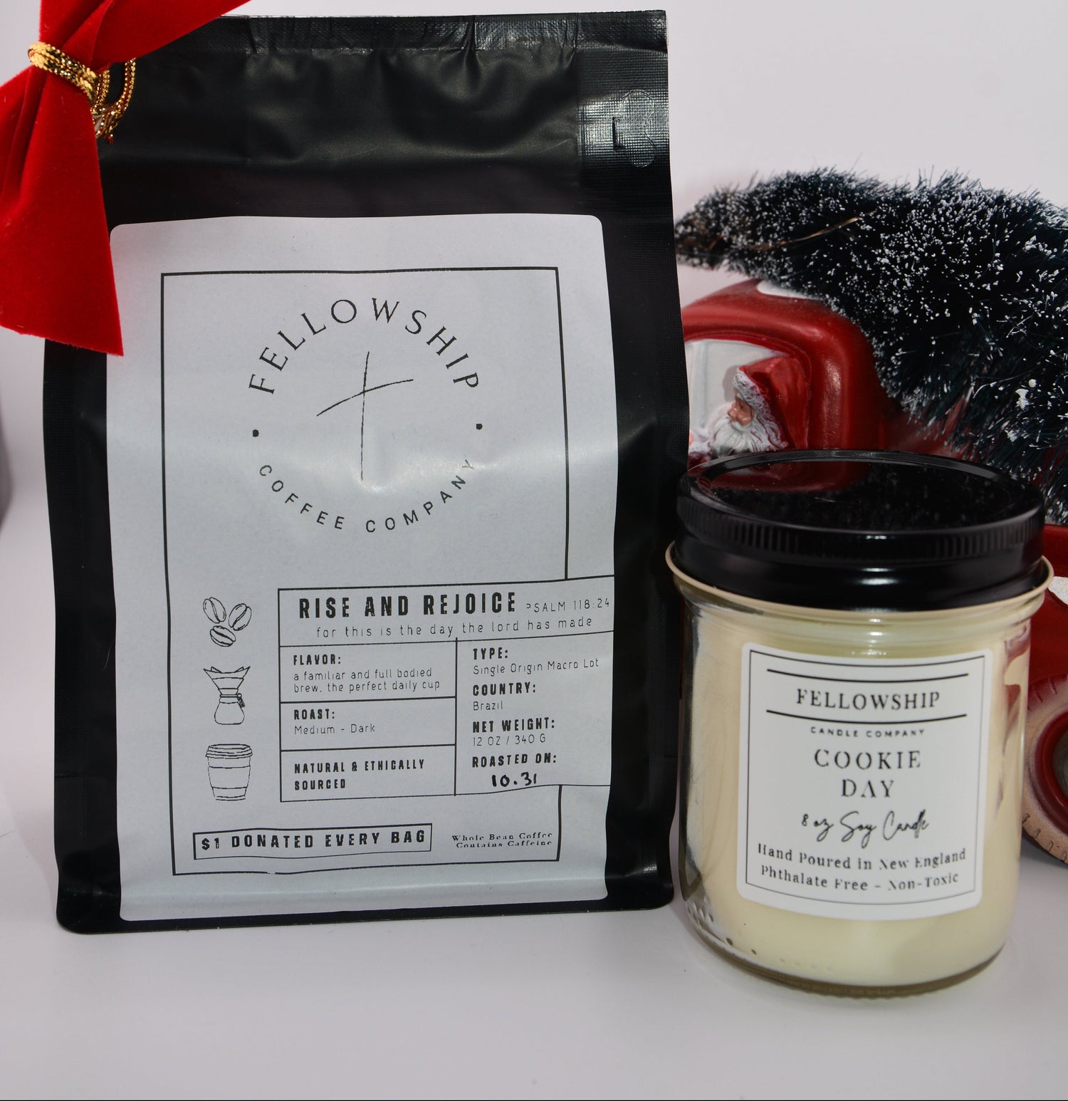 Fellowship Coffee Company package and candle with a red bow on a white background